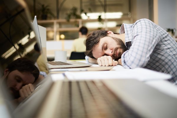 man sleeping at desk