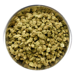 Bowl filled with Tangerine Dream THCA flower buds showcasing frosty green nugs and bright orange pistils.